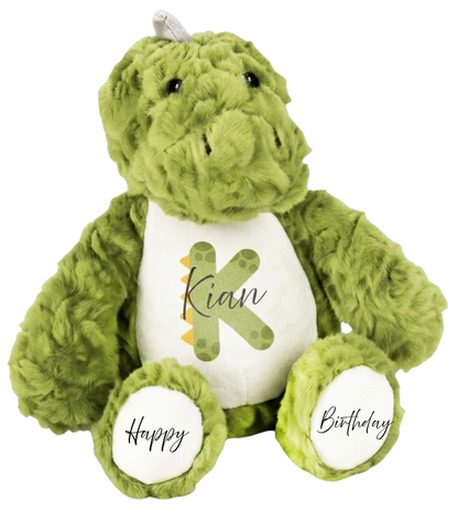 Personalised green dinosaur plush toy with name Kian, initial K and Happy Birthday on feet