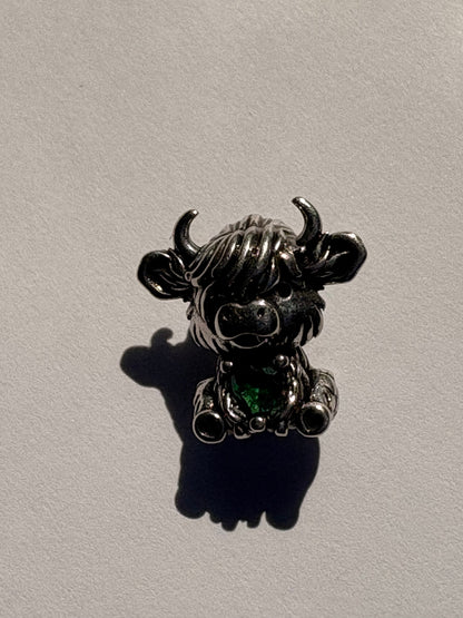 Silver antique finish highland cow charm with green heart gemstone, front view