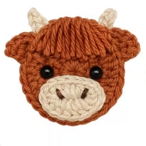 Handmade crochet highland cow face applique in rusty brown and cream yarn with black button eyes