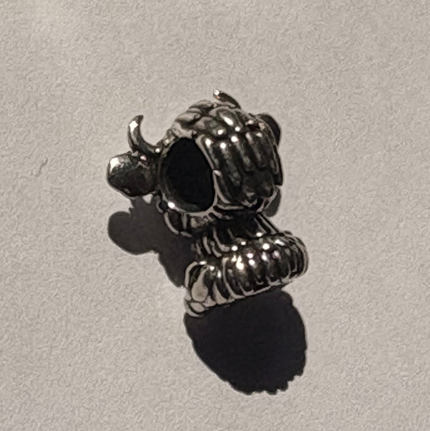 Silver highland cow charm back view showing bracelet hole