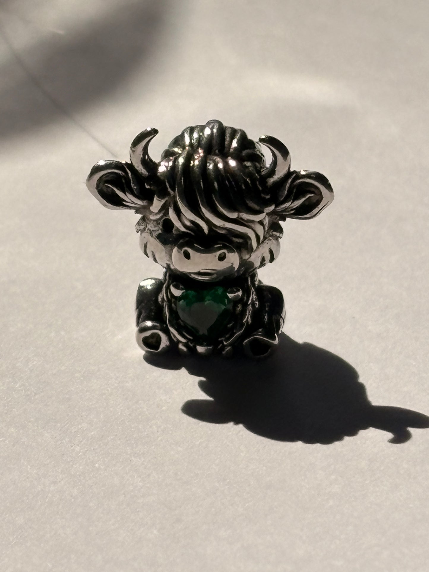 Silver highland cow charm close up detail