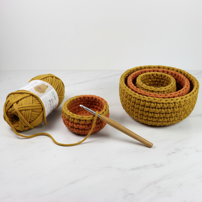 Stages of making a crochet bowl in mustard yellow