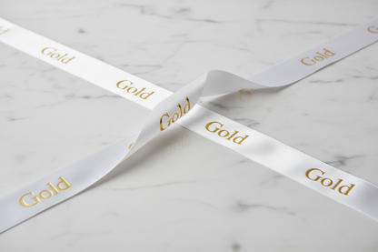White ribbon gold writing